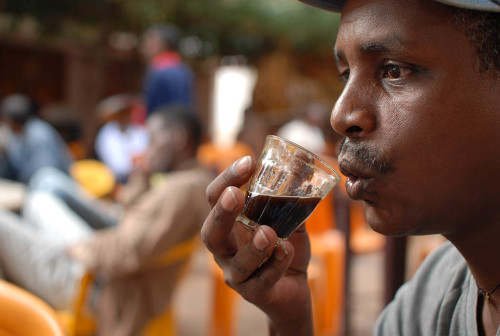 Negash drinking coffee at roadside coffee bar